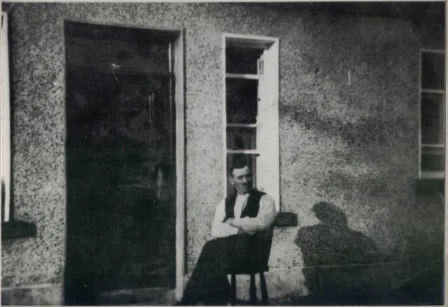 John Keaveney outside the replaced front door, circa 1940.